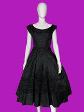 Load image into Gallery viewer, A black sleeveless fit-and-flare dress with cap sleeves, a scoop neckline, and ornate lace and bead trim details, displayed on a white mannequin.