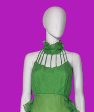 Load image into Gallery viewer, A close up of a bright green halter-neck midi dress with bodice cut outs and ruffle details, displayed on a white mannequin.
