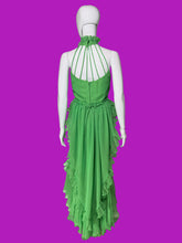 Load image into Gallery viewer, A bright green halter-neck maxi dress displayed on a white mannequin.