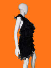 Load image into Gallery viewer, Black ruffled tulle dress shown on a white mannequin featuring a tiered ruffle skirt and a sheer ruffled collar.