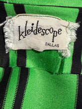 Load image into Gallery viewer, Close-up of a green and black striped knit garment with a frayed white fabric label reading 'Kleidescope DALLAS'.