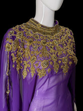 Load image into Gallery viewer, A purple long-sleeve sheer top with elaborate gold beaded floral embroidery across the chest and shoulders, displayed on a white mannequin torso.