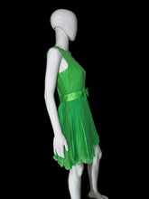 Load image into Gallery viewer, A bright green sleeveless dress displayed on a white mannequin. The dress has a lace V-neck bodice, a matching green bow at the waist, and a pleated tulle skirt.