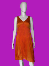 Load image into Gallery viewer, An orange sleeveless fringe dress displayed on a white mannequin.