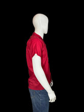 Load image into Gallery viewer, Mannequin wearing a red shirt and blue jeans on a white background
