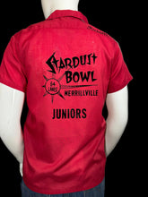 Load image into Gallery viewer, Red shirt with black text on a mannequin against a gray background