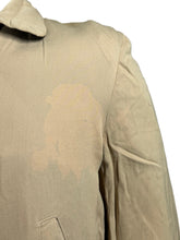 Load image into Gallery viewer, Close-up of a beige fabric with a stain on a gray background