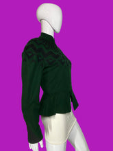 Load image into Gallery viewer, A dark green knit jacket with a black geometric pattern across the yoke and shoulders, displayed on a white mannequin.