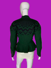 Load image into Gallery viewer, A dark green knit jacket with a black geometric pattern across the yoke and shoulders, displayed on a white mannequin.