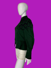 Load image into Gallery viewer, A dark green knit jacket with a black geometric pattern across the yoke and shoulders, displayed on a white mannequin.