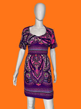 Load image into Gallery viewer, A purple and pink paisley print short-sleeve dress displayed on a white mannequin.