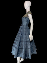 Load image into Gallery viewer, A blue tiered taffeta dress with a patterned lace shoulder yoke, displayed on a white mannequin.