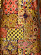 Load image into Gallery viewer, A close-up of a patchwork-style printed textile with multiple rectangular panels in yellow, coral, orange, and dark navy, featuring geometric and floral motifs.