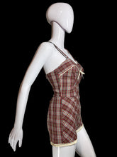 Load image into Gallery viewer, A side view of a brown, red, green, and beige plaid bathingsuit displayed on a white mannequin.