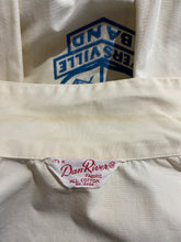 Load image into Gallery viewer, Close-up of a cream-colored jacket collar showing age discoloration.