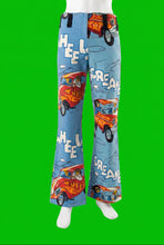 Load image into Gallery viewer, Blue wide-leg pants with a cartoon hot rod print, displayed on a white mannequin.