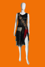 Load image into Gallery viewer, A 1920s drop waist sleeveless black dress with sheer ruffled layered skirt and red sash featuring a diagonal floral embroidery across the bust.