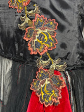 Load image into Gallery viewer, Coral, navy, and yellow embroidered floral applique on black satin fabric leading into a red velvet hip sash.