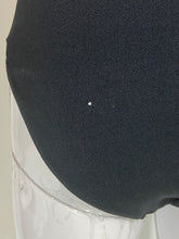 Load image into Gallery viewer, Close-up of a black textured fabric surface with a small white hole in the center.
