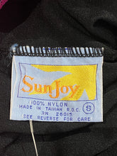 Load image into Gallery viewer, Close-up of a sewn-on brand label reading Sunjoy, made of 100% nylon, on a black garment.