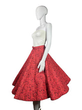 Load image into Gallery viewer, Mannequin wearing a red patterned skirt on a plain background
