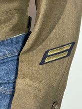 Load image into Gallery viewer, Close-up of a military-style patch on a jacket sleeve with a neutral background