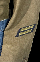 Load image into Gallery viewer, Close-up of a military-style patch on a jacket sleeve with a neutral background