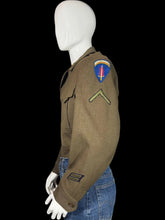 Load image into Gallery viewer, Green WWII army jacket and blue jeans on a mannequin against a plain background