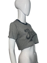 Load image into Gallery viewer, Gray athletic shorts with a logo on a mannequin against a plain background