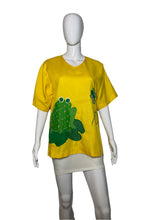 Load image into Gallery viewer, Mannequin wearing a yellow shirt with green frog design on a plain background