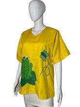 Load image into Gallery viewer, Yellow shirt with green frog design on a mannequin against a white background
