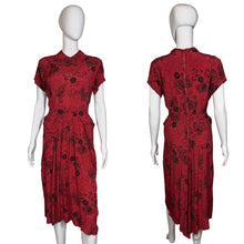 Load image into Gallery viewer, Red dress with black floral pattern on a mannequin against a white wall.
