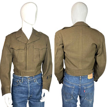 Load image into Gallery viewer, Green WWII army jacket and blue jeans on a mannequin against a plain background
