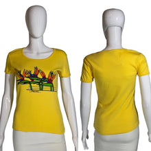 Load image into Gallery viewer, Yellow t-shirt with a colorful design on a mannequin against a gray background
