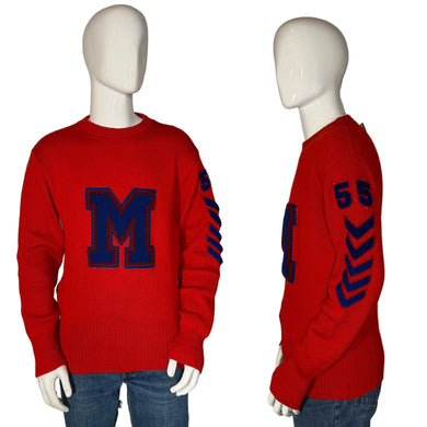 Red sweater with blue letter 'M' and numbers on a mannequin against a plain background