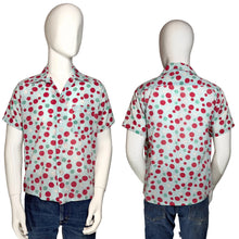 Load image into Gallery viewer, Short-sleeve shirt with red and green polka dot smiley face pattern on mannequin against a plain background
