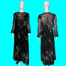 Load image into Gallery viewer, A black sheer maxi dress with metallic gold floral patterns, shown from both the front and back on a white mannequin.

