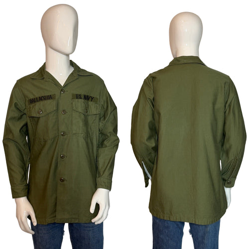 Green military-style jacket on mannequins with visible branding, on a white background
