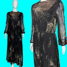 Load image into Gallery viewer, A black sheer long-sleeve maxi dress with gold metallic floral embroidery, shown on a white mannequin. The left panel shows the full dress on the mannequin, and the right panel is a closer front view of the bodice and upper skirt.
