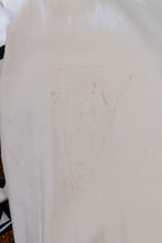 Load image into Gallery viewer, Off white fabric with brown stain on the right sleeve
