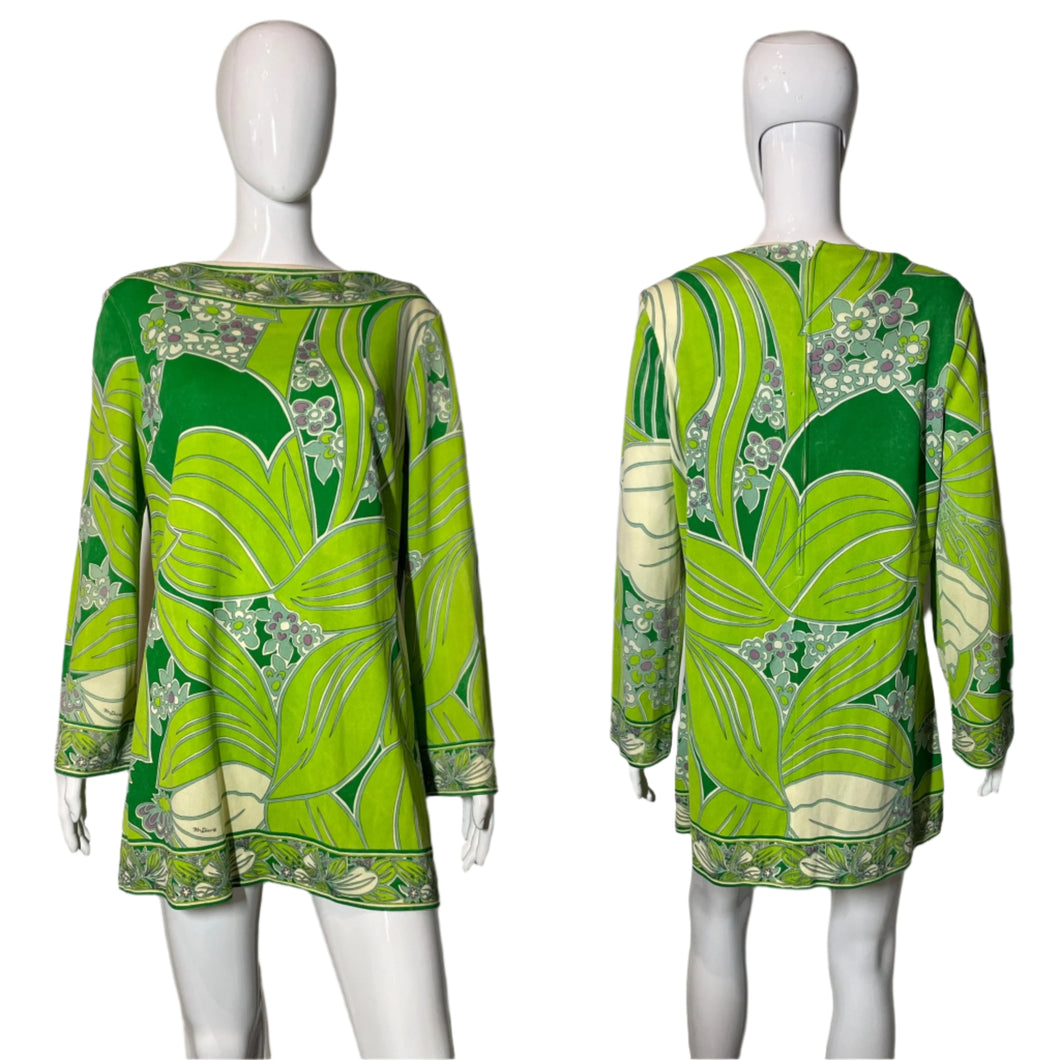 Green and white patterned dress on a mannequin against a plain background