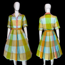 Load image into Gallery viewer, A vintage-style short-sleeve dress with a colorful plaid pattern, shown on a white mannequin from both the front and back views.
