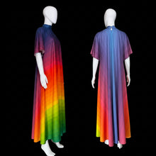 Load image into Gallery viewer, A long, short-sleeved dress displayed on a white mannequin from both front and back views. The dress features a vibrant rainbow gradient transitioning from dark purple at the shoulders to red, orange, yellow, green, and blue at the hem.
