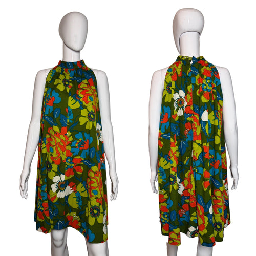 Colorful floral dress on a mannequin against a plain background