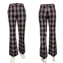 Load image into Gallery viewer, Black and white plaid pants on a mannequin against a plain background
