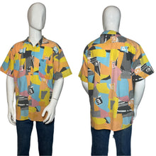 Load image into Gallery viewer, Colorful geometric patterned shirt on a mannequin against a gray background
