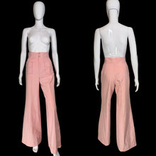 Load image into Gallery viewer, A pair of high-waisted, wide-leg pink pants displayed on a white mannequin. The pants feature a buttoned waistband with gold-tone buttons and two large patch pockets in the front. 
