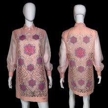Load image into Gallery viewer, A pink embroidered tunic dress shown on a white mannequin from both front and back views. The dress features long sheer sleeves, a mandarin collar, and intricate floral and scroll embroidery in pink, purple, and gold.
