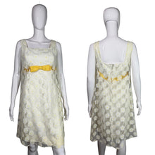 Load image into Gallery viewer, White floral dress with yellow bow on a mannequin background
