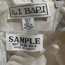 Load image into Gallery viewer, Close-up of a garment interior showing two labels reading A.J BARI.
